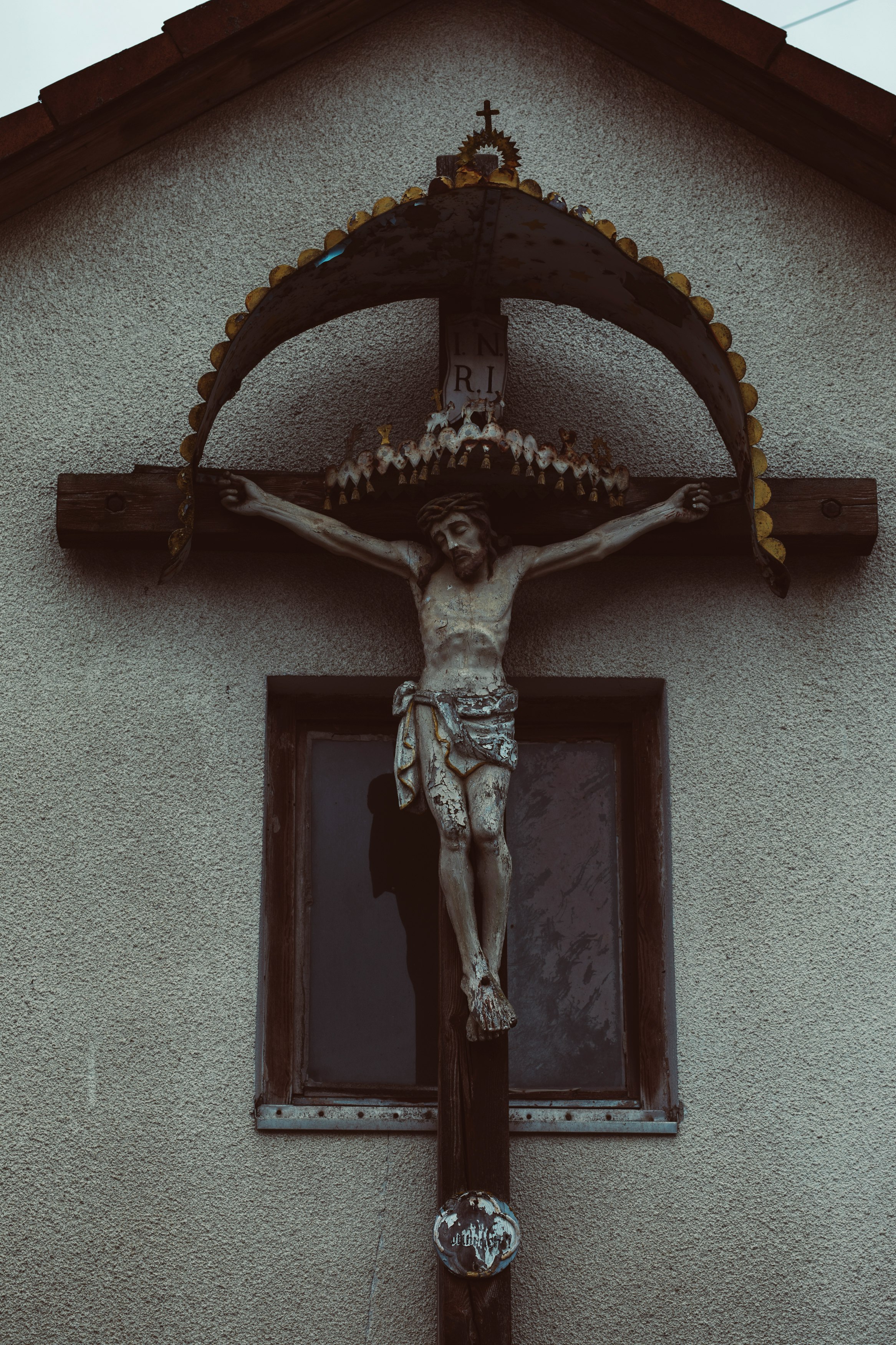 black and gold cross on white wall